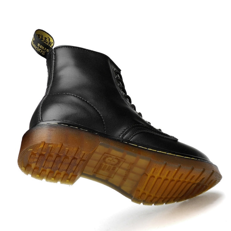Black lace-up ankle boots with yellow stitching and chunky rubber outsole