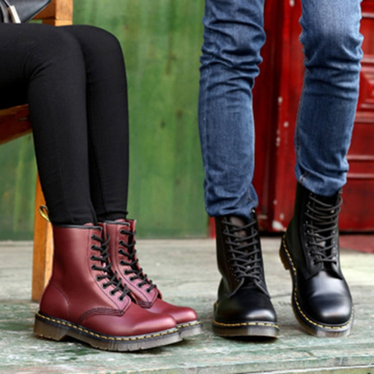 Pair of lace-up boots: red wine and black with chunky soles and yellow stitching