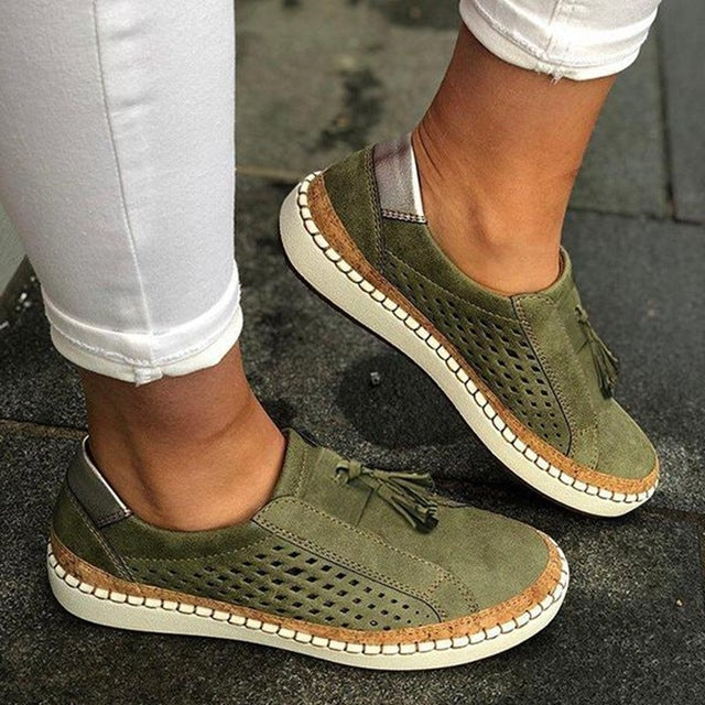 Green breathable women’s slip-on sneakers with perforations and tassel detail, white sole
