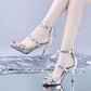Silver peep-toe high heel sandals with star embellishments and ankle straps