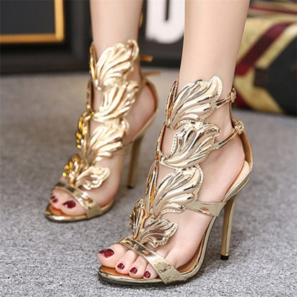 Gold metal wing peep-toe high heel sandals with ankle strap and sculpted wing overlay