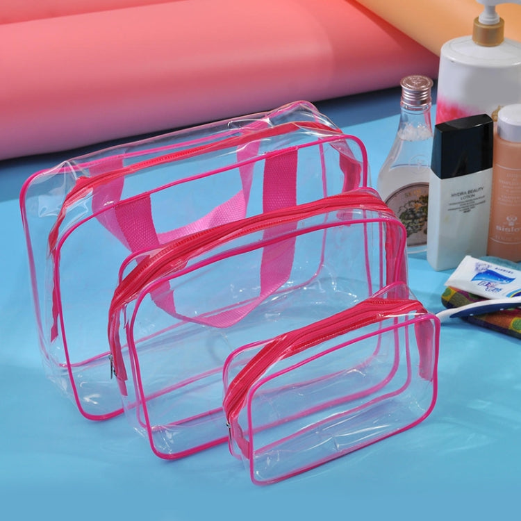 Set of clear PVC toiletry bags with pink frame and zippers, three stacked pouches