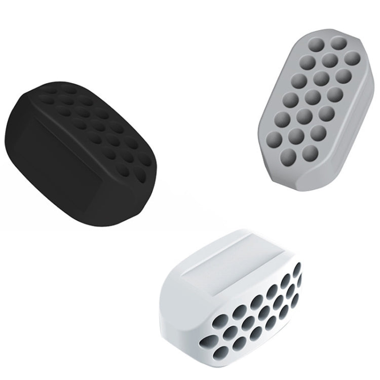 Silicone masseter ball jaw trainer in black, gray, and white with round bump rows