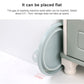Light blue collapsible washbasin with side handle, shown near a flat storage setup.