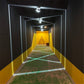 LED semicircle wall spotlights lining a hallway with bright white light strips