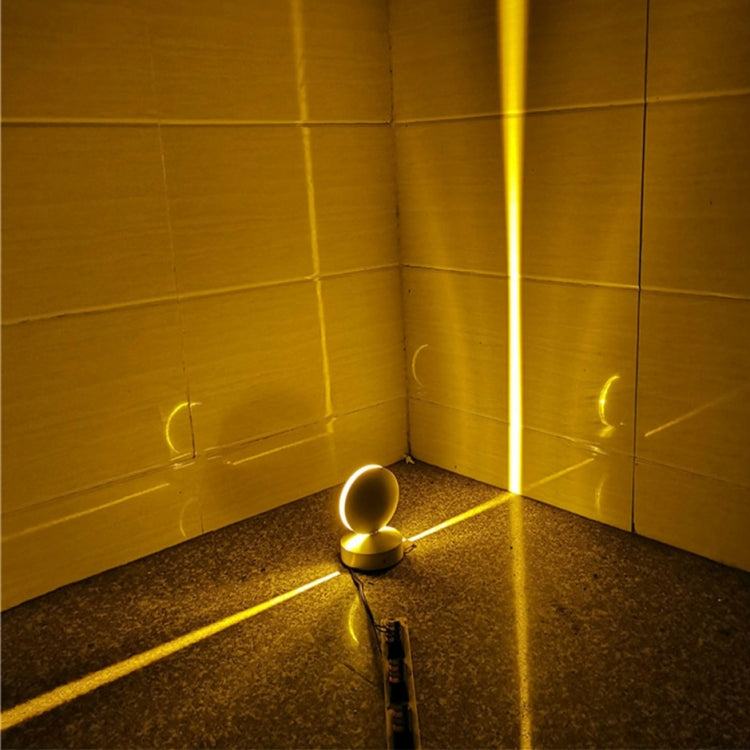 LED wall spotlight with semicircle head glowing warm yellow in corner