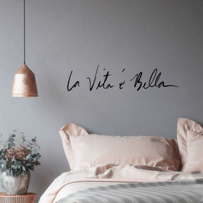 Black cursive wall sticker decal reading 'La Vita e Bella'.