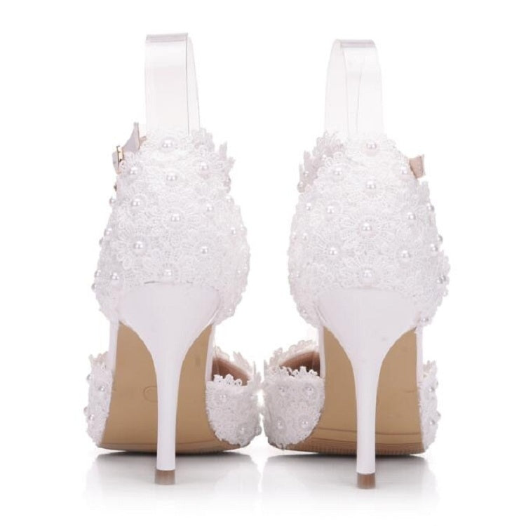 Pair of white lace high-heel shoes with back straps and pearl-like bead embellishments