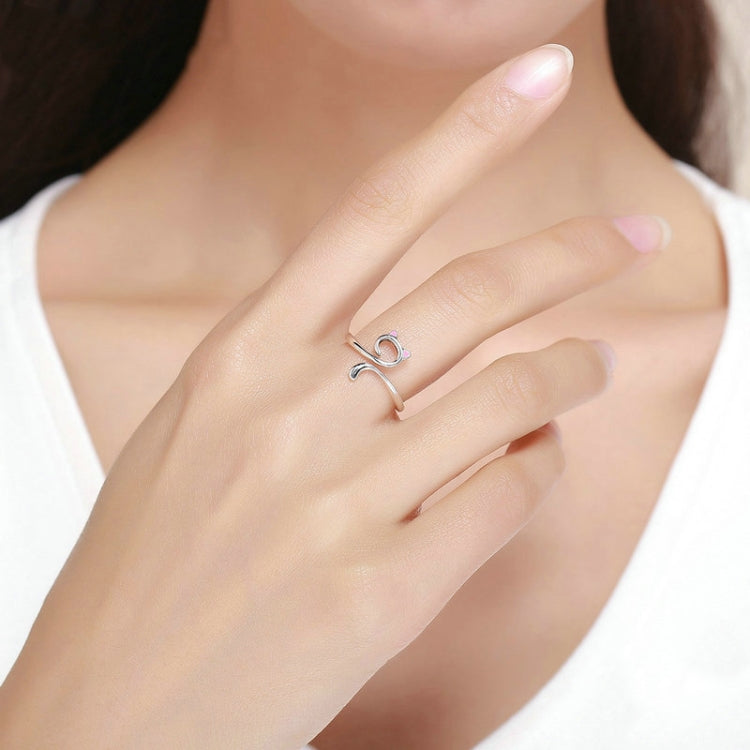 Sterling silver open cat ring with pink enamel details on hand