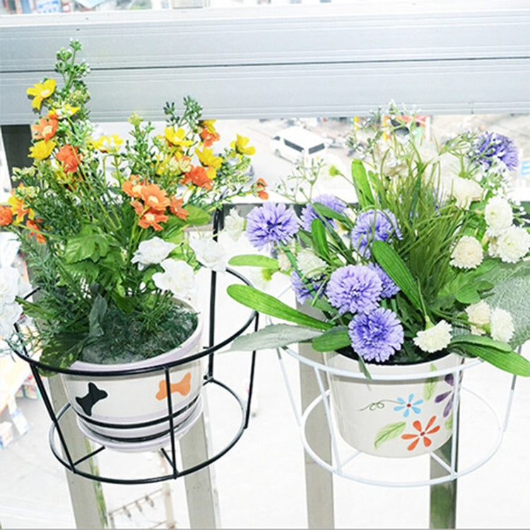 Black metal flower pot stand holding flowers in round planters on a rail