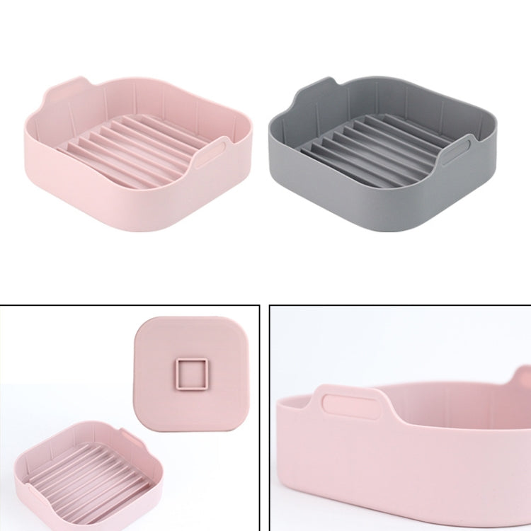 Silicone square grill pan inserts in pink and gray, each with ridged grilling surface