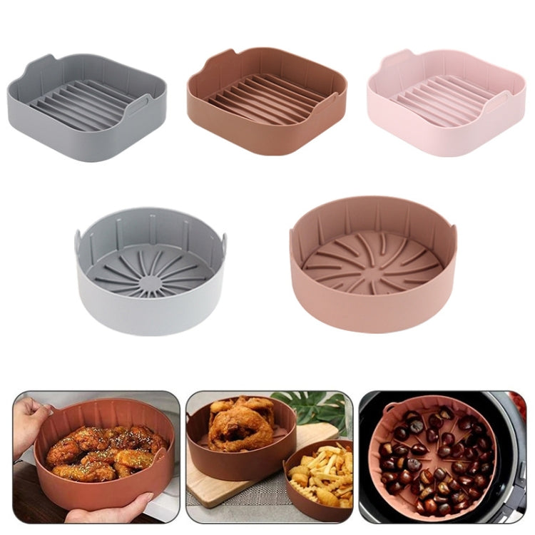 Assorted silicone air fryer grill pan inserts in gray, brown, and pink, with ridged surface