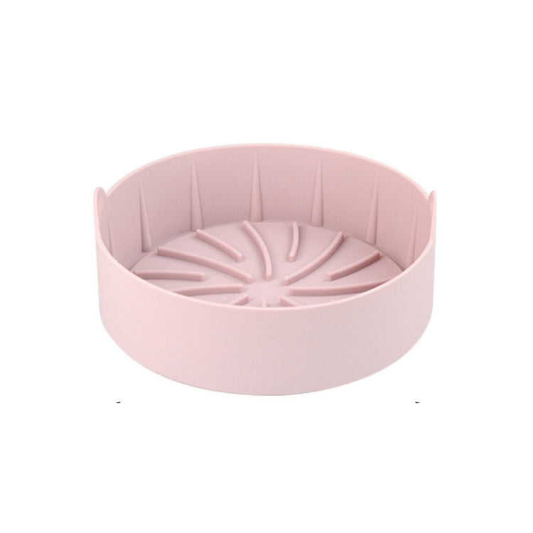 Pink round silicone grill pan insert with ridged radial channels and center hub