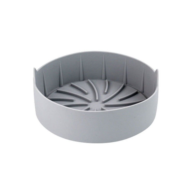 Gray round silicone grill pan insert with ridged radial channels and center hub