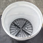 White bucket with black circular sand-filter net insert, grid pattern and center ring