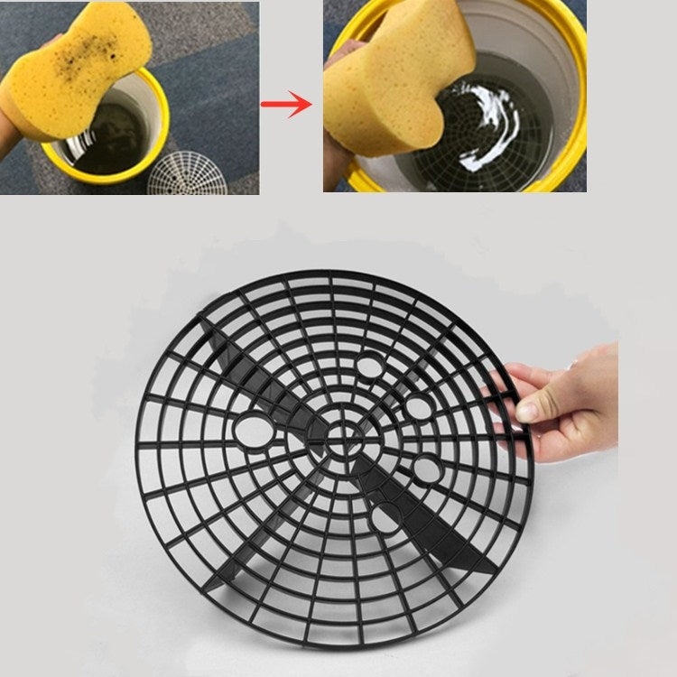Black circular sand and stone isolation filter net disc held by hand, grid spokes visible