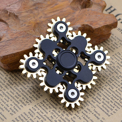 Black gear linkage fidget spinner with brass teeth and five rotating discs