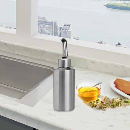 Stainless steel oil sprayer bottle with cylindrical body and black pump nozzle