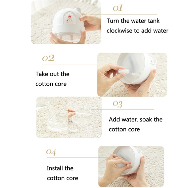 Hands holding snowman humidifier water tank, adding water to cotton core.