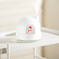 White snowman humidifier night light on shelf, red snowman icon in front dome.