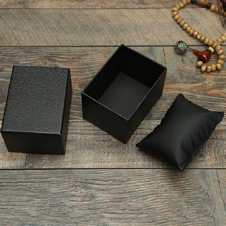 Black textured jewelry box open with inner tray and padded ring bag