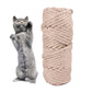 Cat pawing toward a beige braided hemp rope scratch roll, cat grip toy