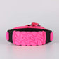 Pink and black jumping shoe sole with textured tread and adjustable strap
