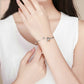 Sterling silver bracelet with bee charm, worn on wrist