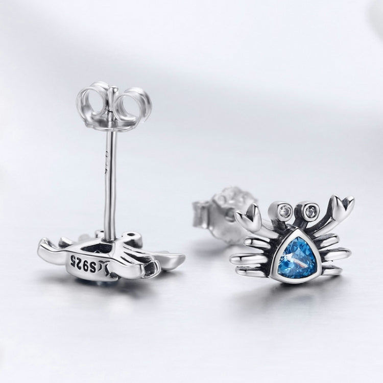 Oxidized silver crab earrings with blue heart-shaped gemstone and butterfly back posts