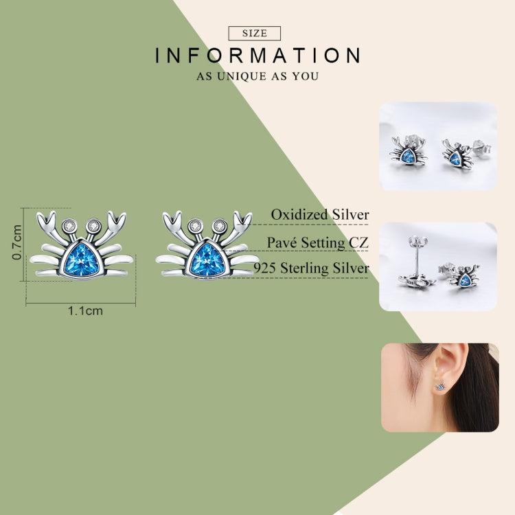 Oxidized silver crab earrings featuring heart-shaped blue gemstone and sparkling crystal details