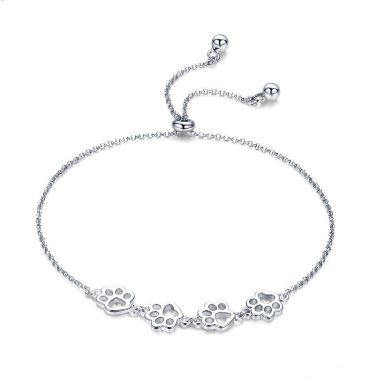 Sterling silver paw print charm bracelet with dangling paw motif on chain
