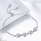 Silver paw print charm bracelet with small claw paw details along the chain