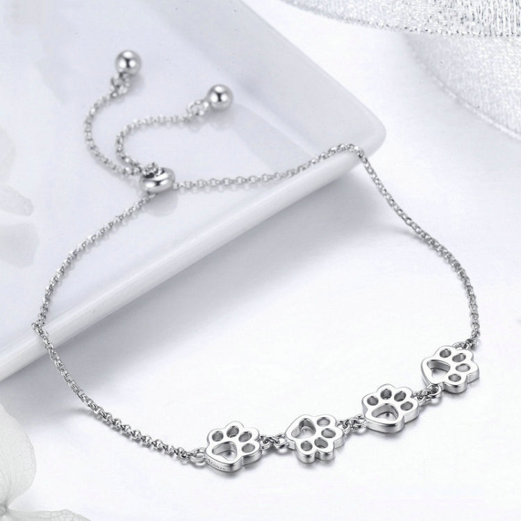 Silver paw print charm bracelet with small claw paw details along the chain