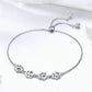Paw print charm bracelet in sterling silver with five paw medallions on chain