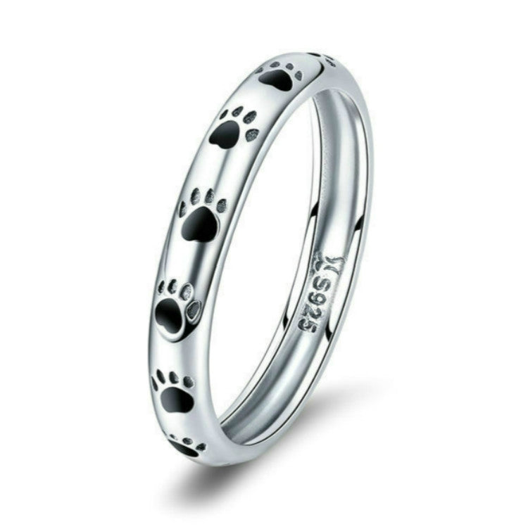 Sterling silver paw print ring with black enamel footprints, polished band