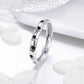 Sterling silver ring with black paw print details along the front band, side view