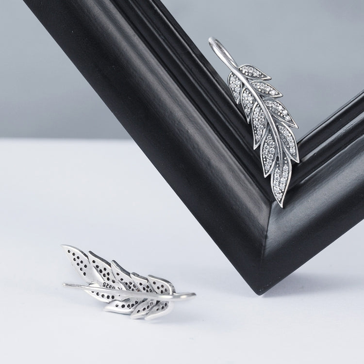 Sterling silver leaf earrings with pavé detailing, shown front and back
