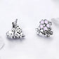 Sterling silver flower stud earrings with pink enamel petals; visible post and back