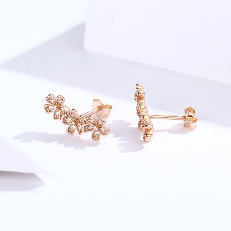 Rose gold flower CZ stud earrings with hoop-style post backs, side view