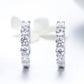 Sterling silver hoop earrings with five clear CZ stones per hoop