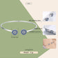 Sterling silver bangle bracelet with two round blue zircon inlaid charms
