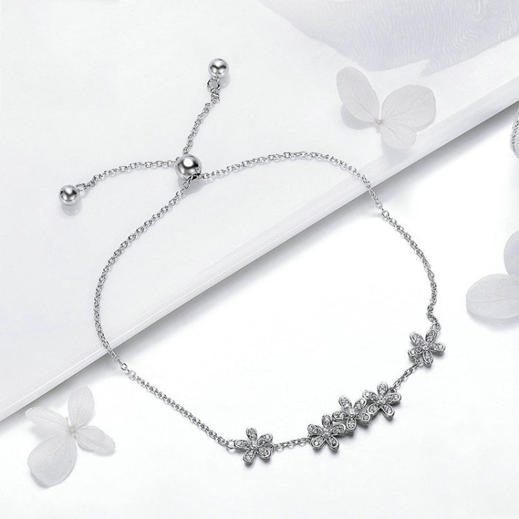 Sterling silver bracelet with dangling flower charms and round bead clasp ends
