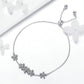 Silver daisy charm bracelet with a row of flower clusters and bead clasp