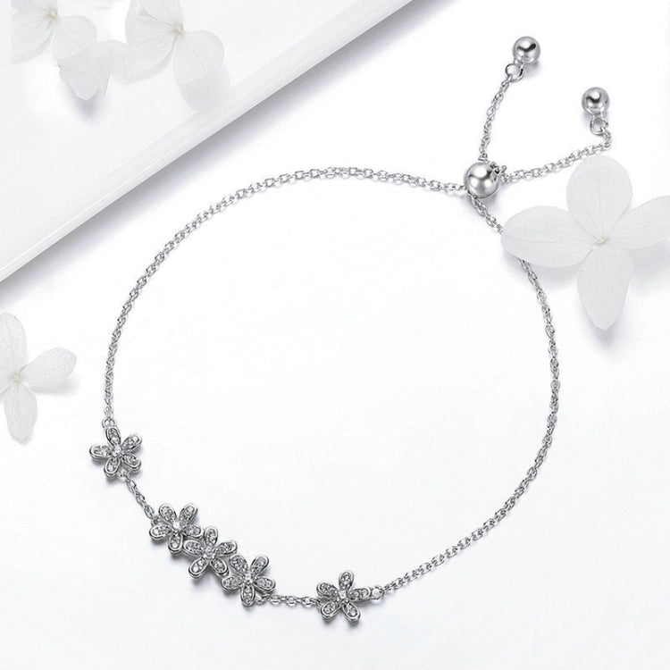 Silver daisy charm bracelet with a row of flower clusters and bead clasp
