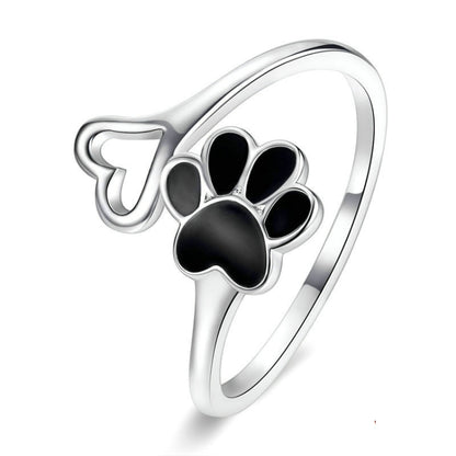 Open paw print sterling silver ring with black enamel details