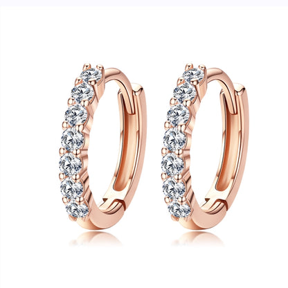 Rose gold hoop earrings with round zircon-like stones in a row