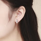Wearing cat-shaped 925 sterling silver stud earrings with small CZ eyes on ear