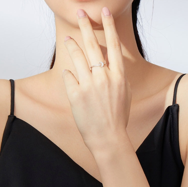 Sterling silver open ring with star and moon zircon detail on a hand