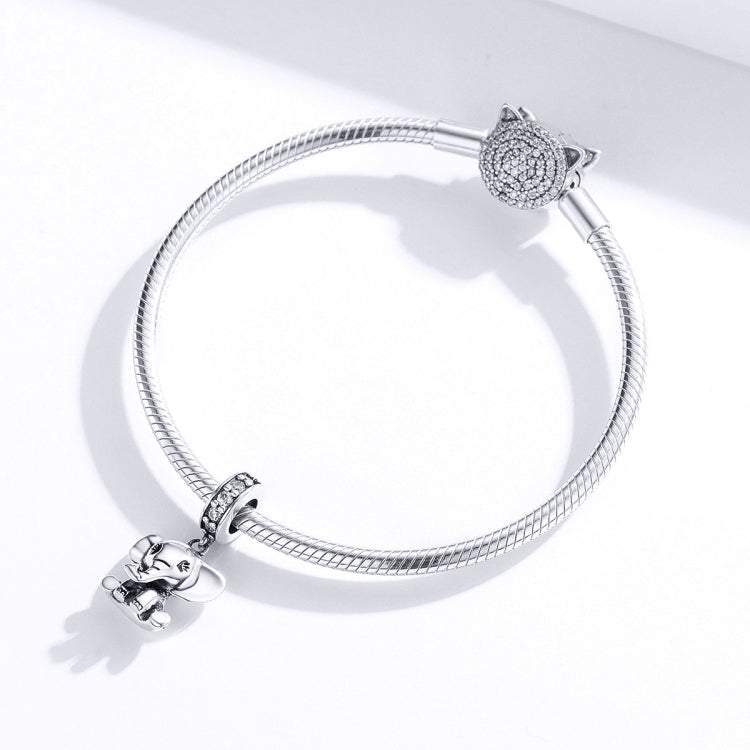 Silver charm bracelet with elephant charm on left and owl charm on right