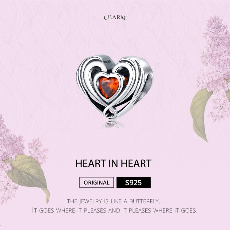 Heart-in-heart charm bead in sterling silver with orange CZ center